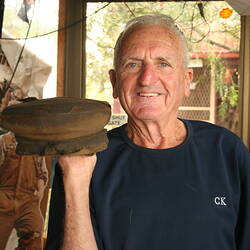 Head & shoulders portrait of Ron Graham, nightsoil carter, holding cap beside his head