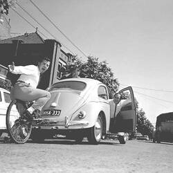 Negative - Television Personalities in Antics with Unicycle & Volkswagen 'Beetle' on Suburban Street, Richmond, Victoria, 1961