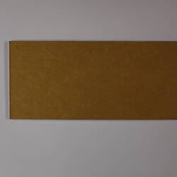 Plain back of a brown exhibition label.