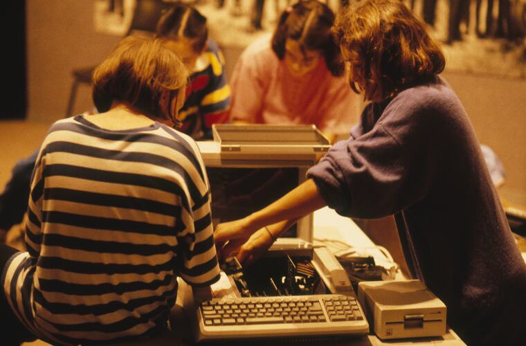 Students setting up computer and printer.