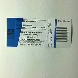 White and blue ticket with black printed text and barcode.