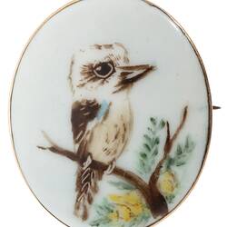 White porcelain brooch with painted kookaburra.