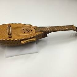 Brown wooden mandolin profile. Carved body. Silver pegs.