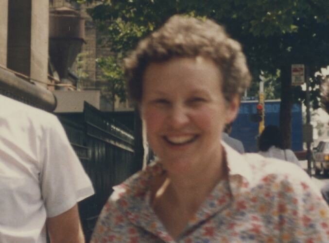 Close-up of woman with curly hair in floral dress