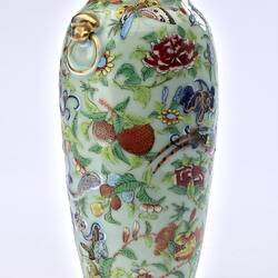 Porcelain vase with all-over pattern of birds, flowers, butterflies and two rats climbing amongst branches.