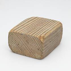 Block of pale-coloured wood.