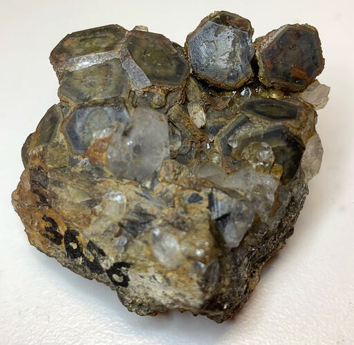 Brown, tan and grey rhombohedral crystals.