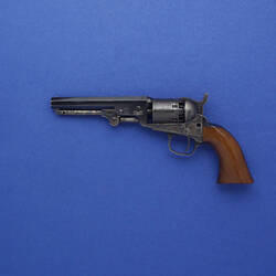 19th century colt revolver with wooden handle and silver barrel