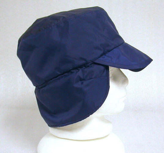 A blue hat with neck flap and brim.