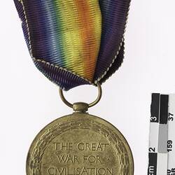 Round bronze medal rainbow with red ribbon, reading "THE GREAT WAR FOR CIVILISATION 1914-1919".