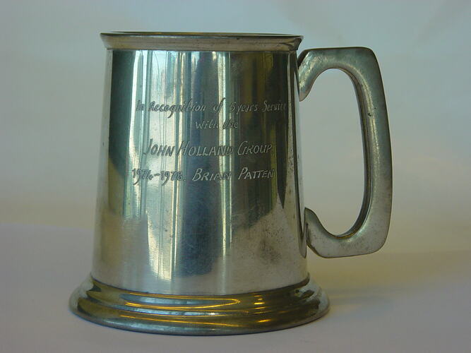 Pewter tankard with inscription on side.