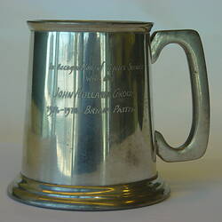 Pewter tankard with inscription on side.