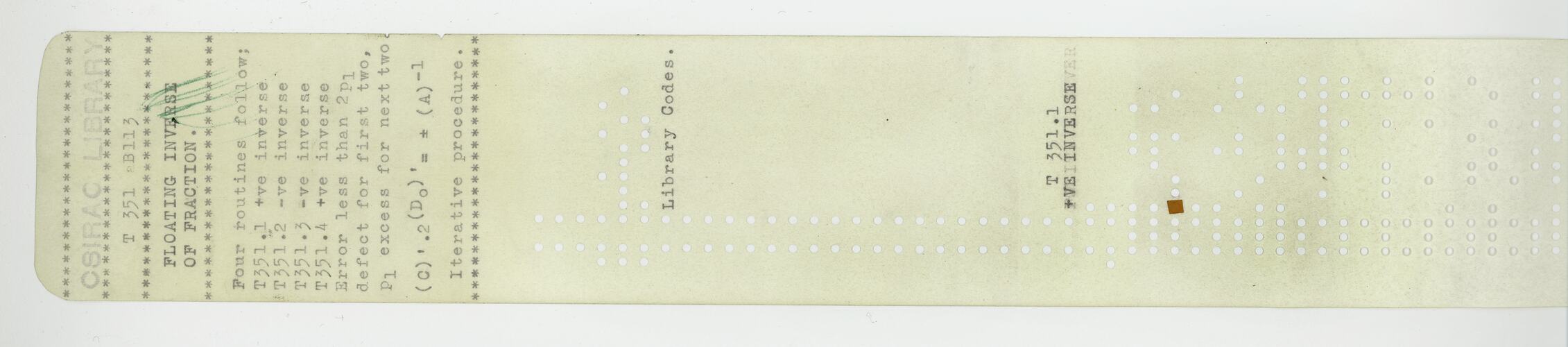 Paper tape with typed text and punched holes.
