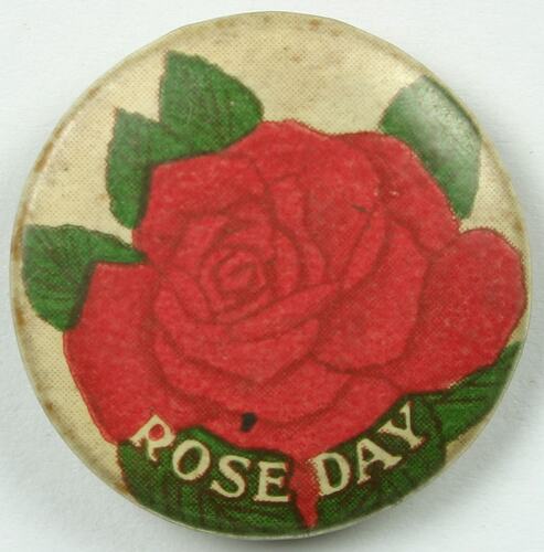 Badge with red rose.