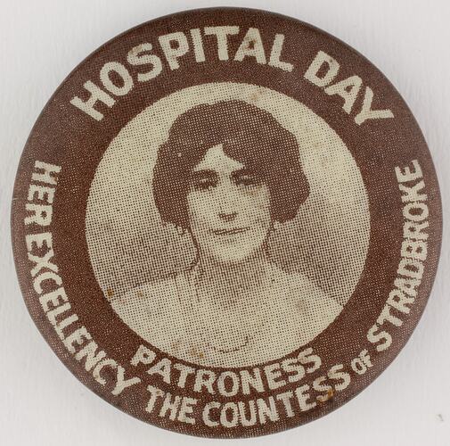 Round brown badge with head image of woman.