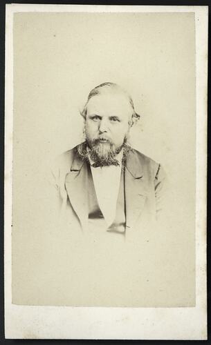 Portrait of bearded man wearing jacket, waistcoat and bow tie.