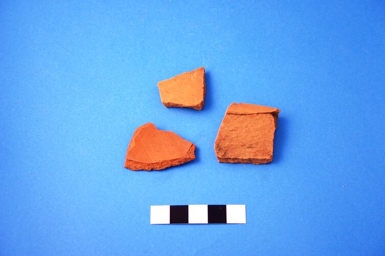 Three terracotta shards.