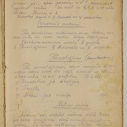 White sheet with handwritten text.