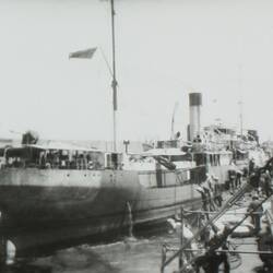 Side view of a navy ship, image taken from deck of another ship.
