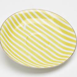 China saucer with yellow and white stripes