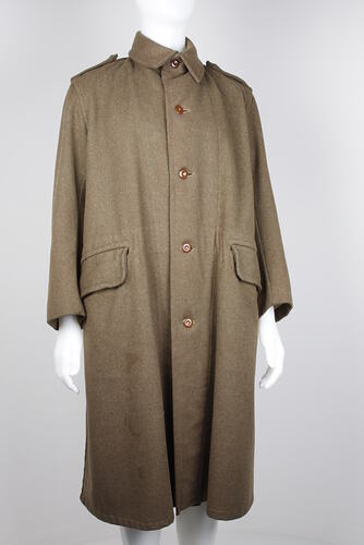 Brown overcoat on mannequin.