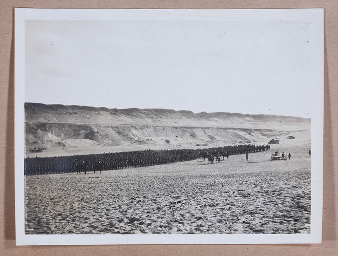 Large group of soldiers standing in formation, handwritten text below.