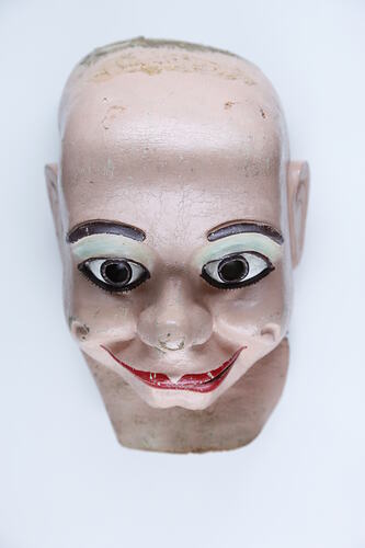 Rubber mask of a doll's face.