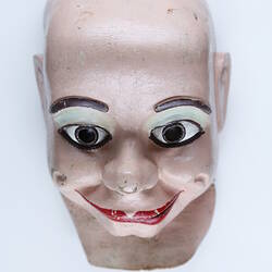 Rubber mask of a doll's face.