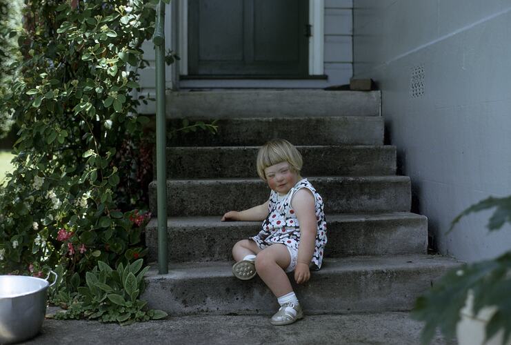 Catherine Black Sitting on Concrete Steps, Newbury, Victoria, circa 1968