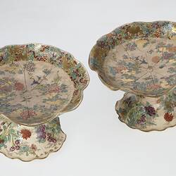 Pair of cream coloured compote with wavy edges decorated with birds & chrysanthemums.