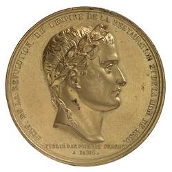 Round medal of male profile facing right.
