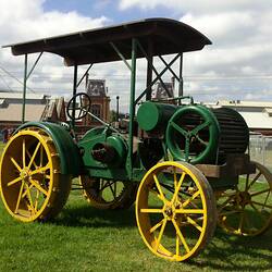 Green 'Sunshine' tractor with yellow painted steel wheels on display at Scienceworks
