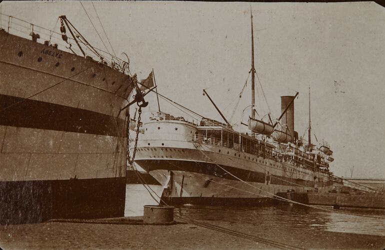 Angle view of two docked hospital ships. Left ship, 'Assaye is partially visible, right ship in full view.
