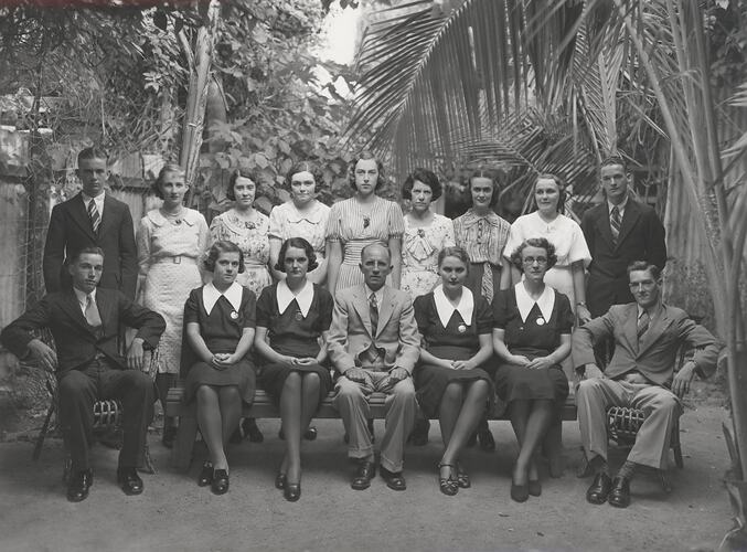 Group portrait of Kodak staff in tropical garden.