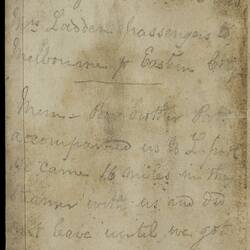 Open diary with handwritten text on discoloured worn page.