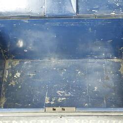 Inside of empty metal box painted navy.