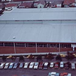 Oblique aerial view of factory building and carpark.