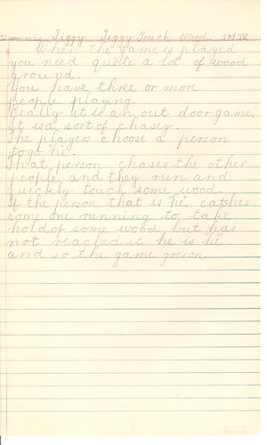 Handwritten game description in pencil on lined paper