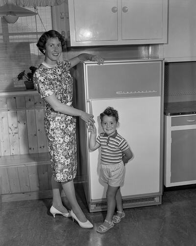 Electrolux Co, Woman & Boy Standing Near a Refrigerator, Surrey Hills, Victoria, 05 Feb 1960