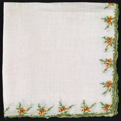 Folded handkerchief with embroidered orange and Yellow Flowers.
