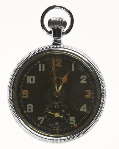 Circular watch face with silver metal rim, silver loop at top and numbers on black watch face.