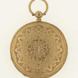 Closed ladies gold pocket watch with ornate design on cover. Ring at top.