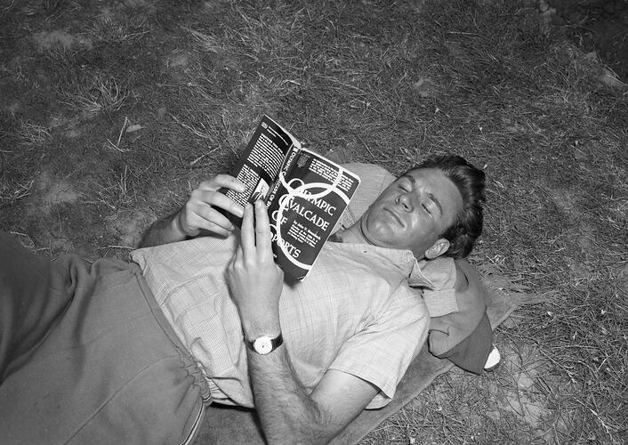 Olympic Athlete Reading From a Book Titled 'Olympic Cavalcade of Sports', Heidelberg West, Victoria, 1956