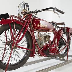 Red motor cycle, left front view.