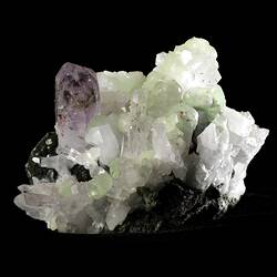 Tall purple crystal with smaller blocky green crystals.