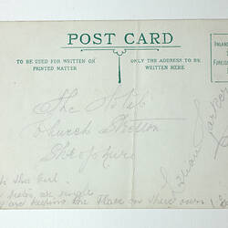 Printed back of postcard with handwriting.