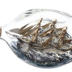 Model sailing ship in glass bottle.