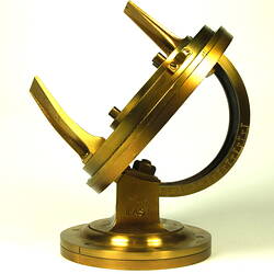 Side view of gold metal chronometer.