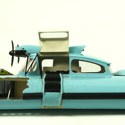 Light blue hovercraft with two propellers, facing left.