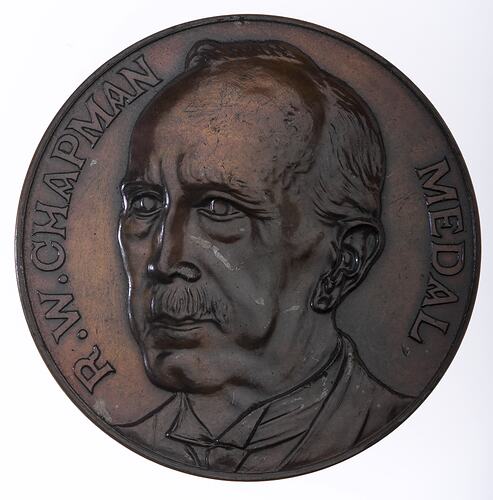 Round medal with 3/4 male portrait bust facing left, text around.